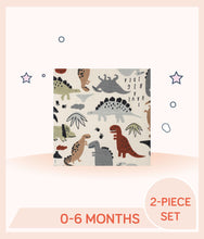 Load image into Gallery viewer, Close up of beige clothing with an allover print of dinosaurs